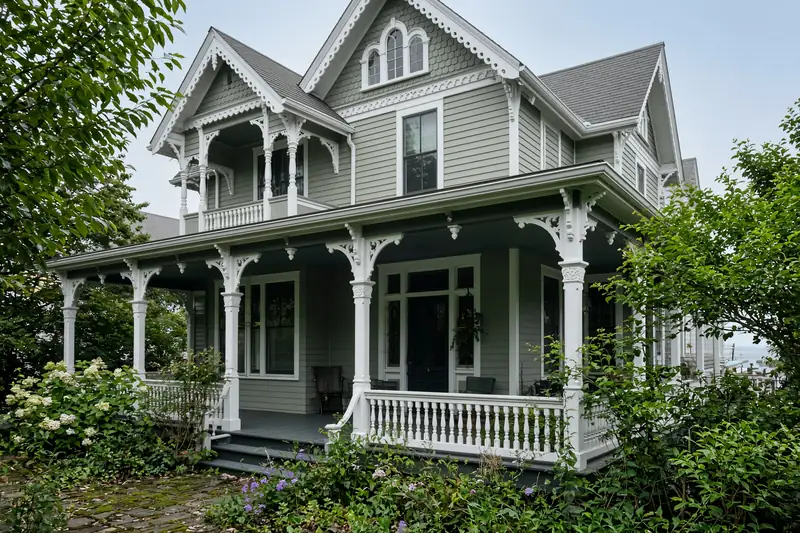 An older painted shore cottage with a deep porch